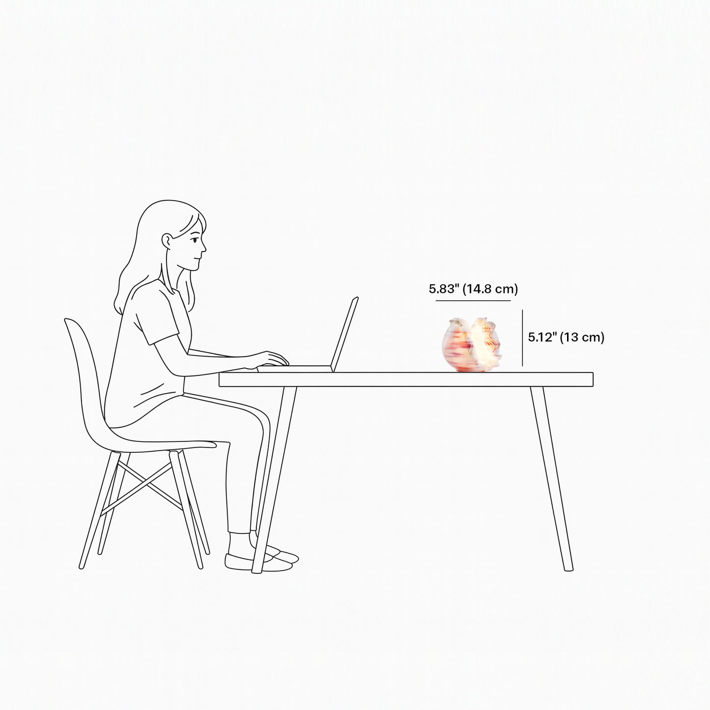 Illustration of a person sitting at a table with a laptop, showing the height difference between the laptop and a small object.
