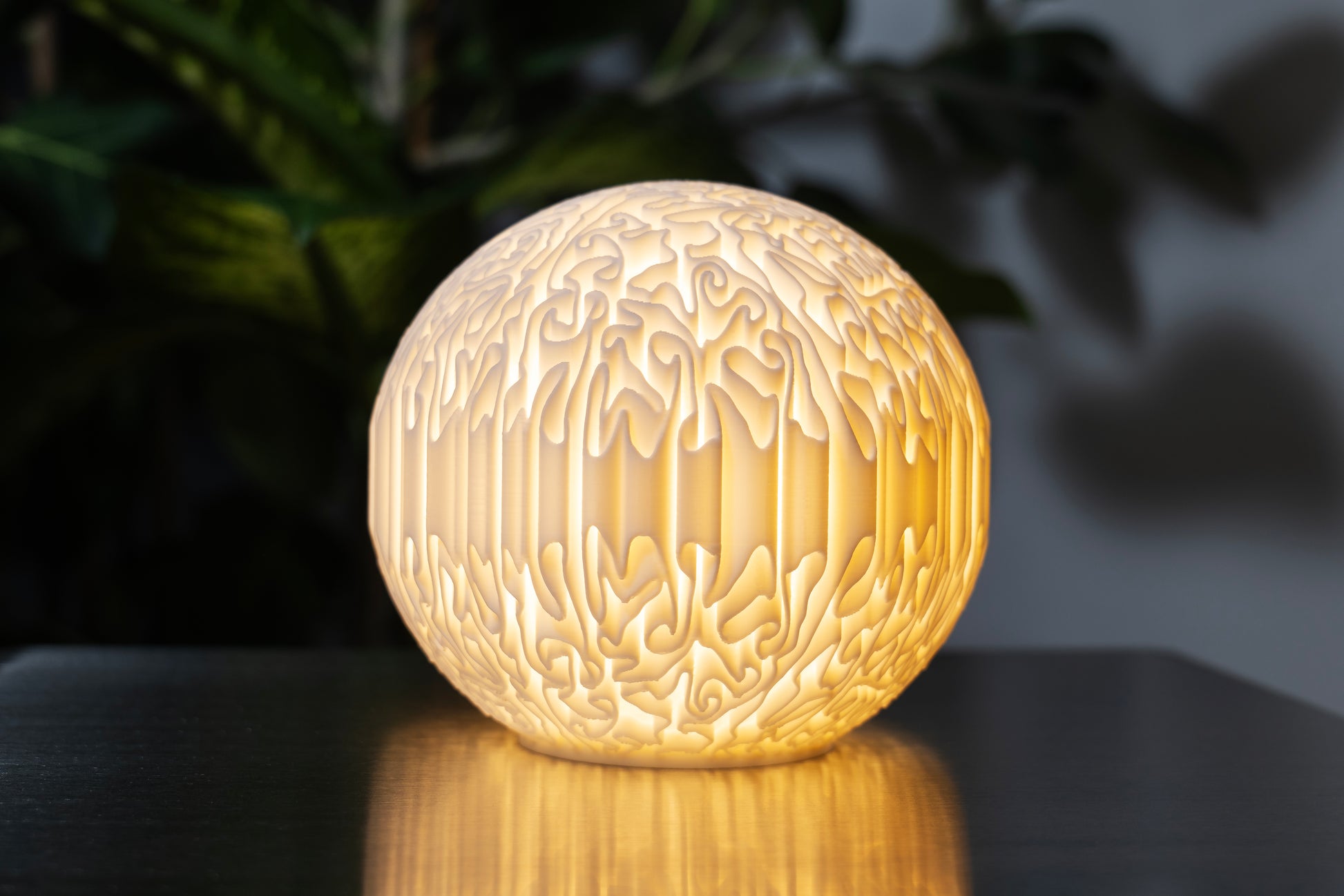 biomorphic sculptural mini lamp with organic flowing surface and warm glowing light