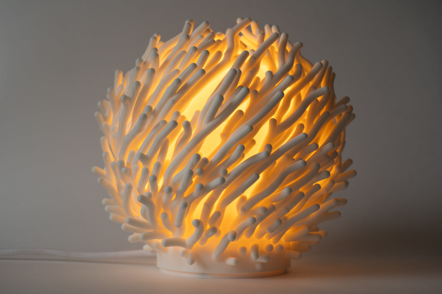 Coral-like lamp with a warm glow on a neutral background