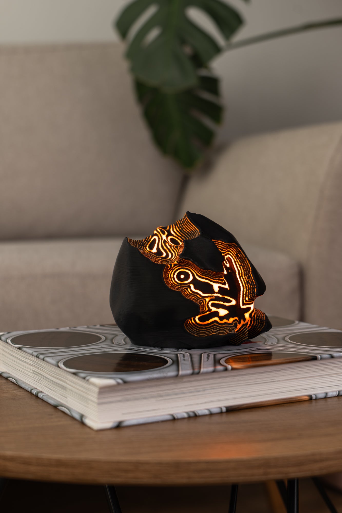 Decorative lamp with glowing design on a magazine on a table with a blurred background