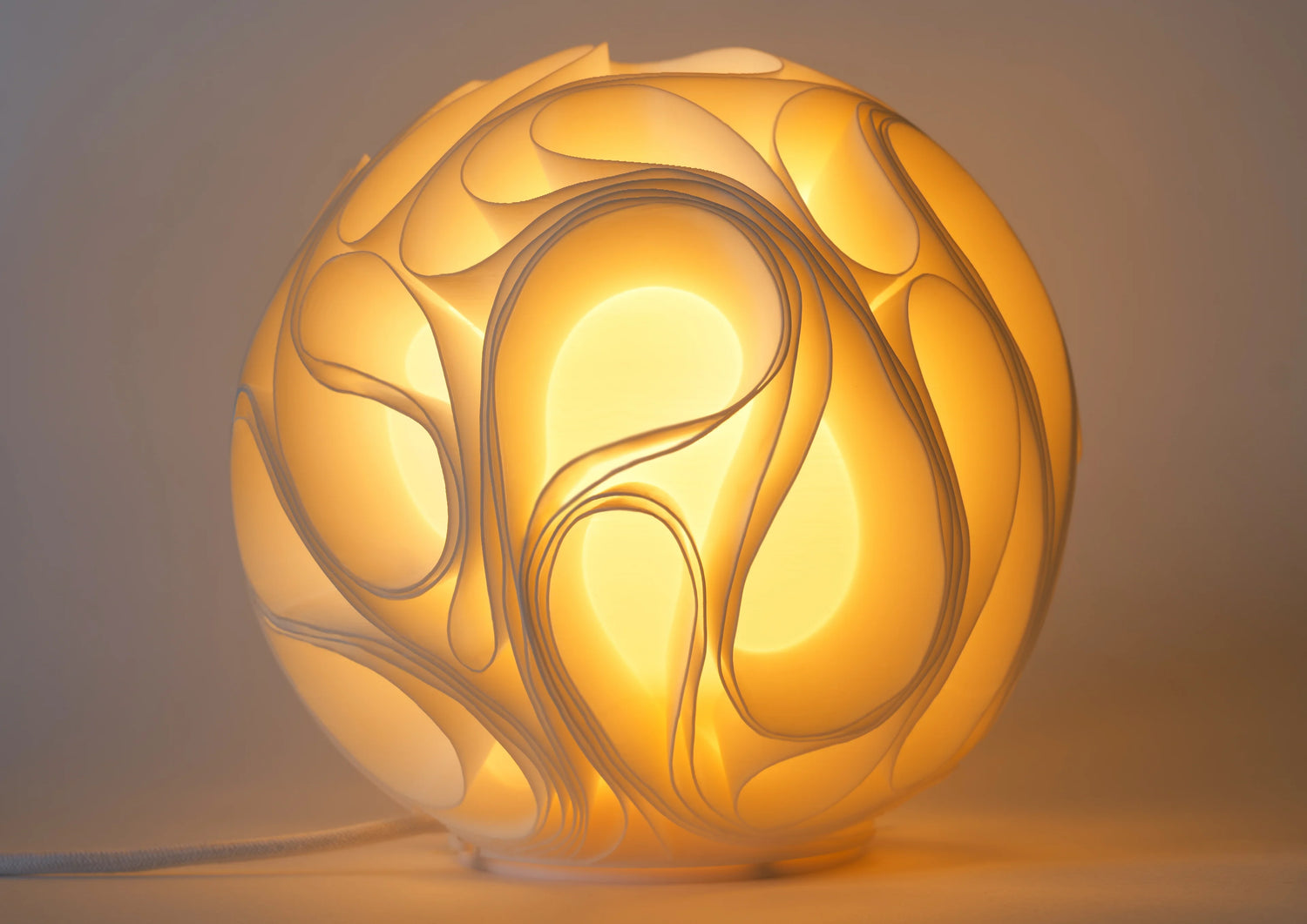 Decorative lamp with swirling design on a plain background