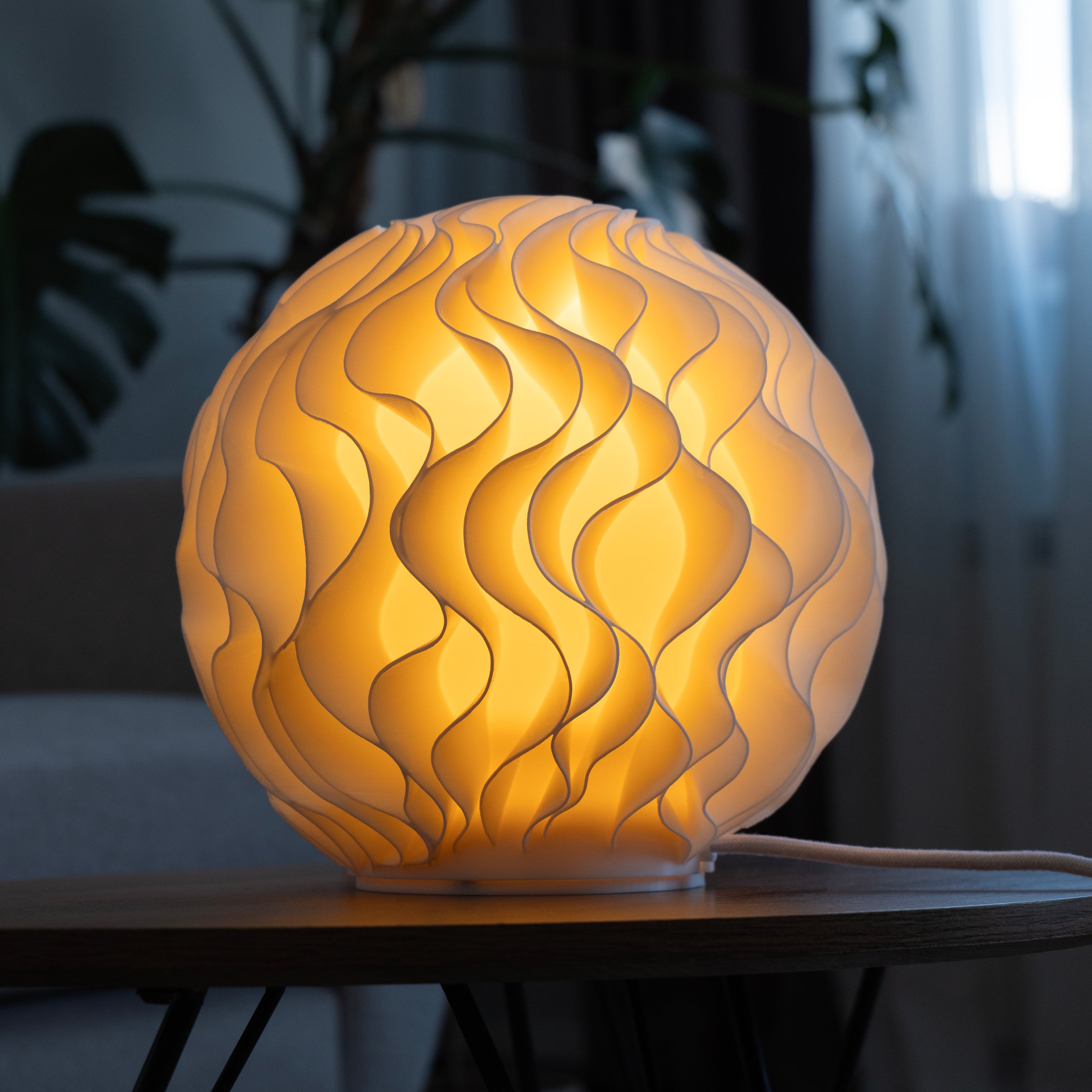 Spherical lamp with wavy design on a wooden surface