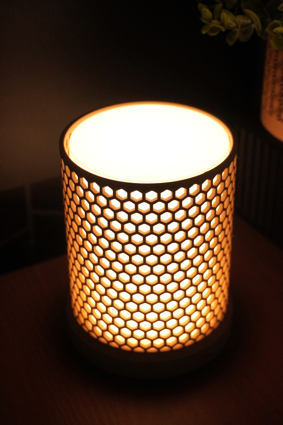 Decorative lamp with honeycomb pattern on a dark background