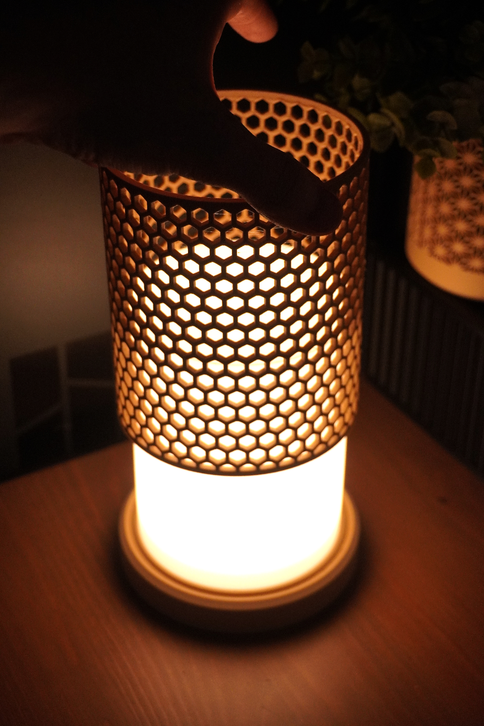 Decorative lamp with honeycomb pattern on a wooden surface