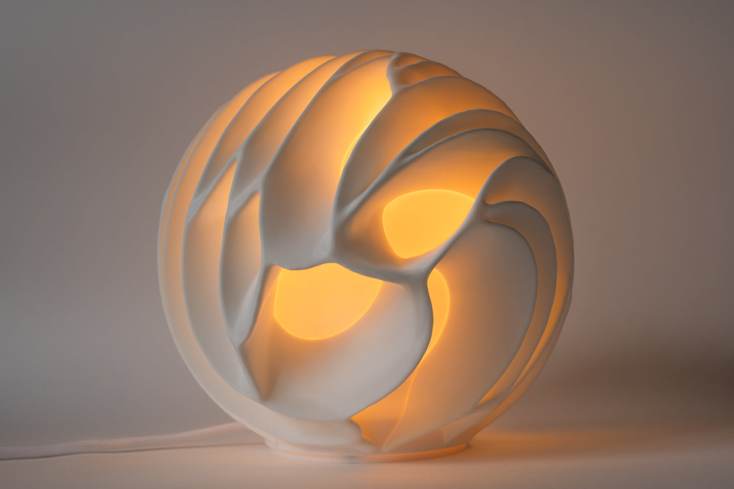 Decorative lamp with a swirling design on a plain background