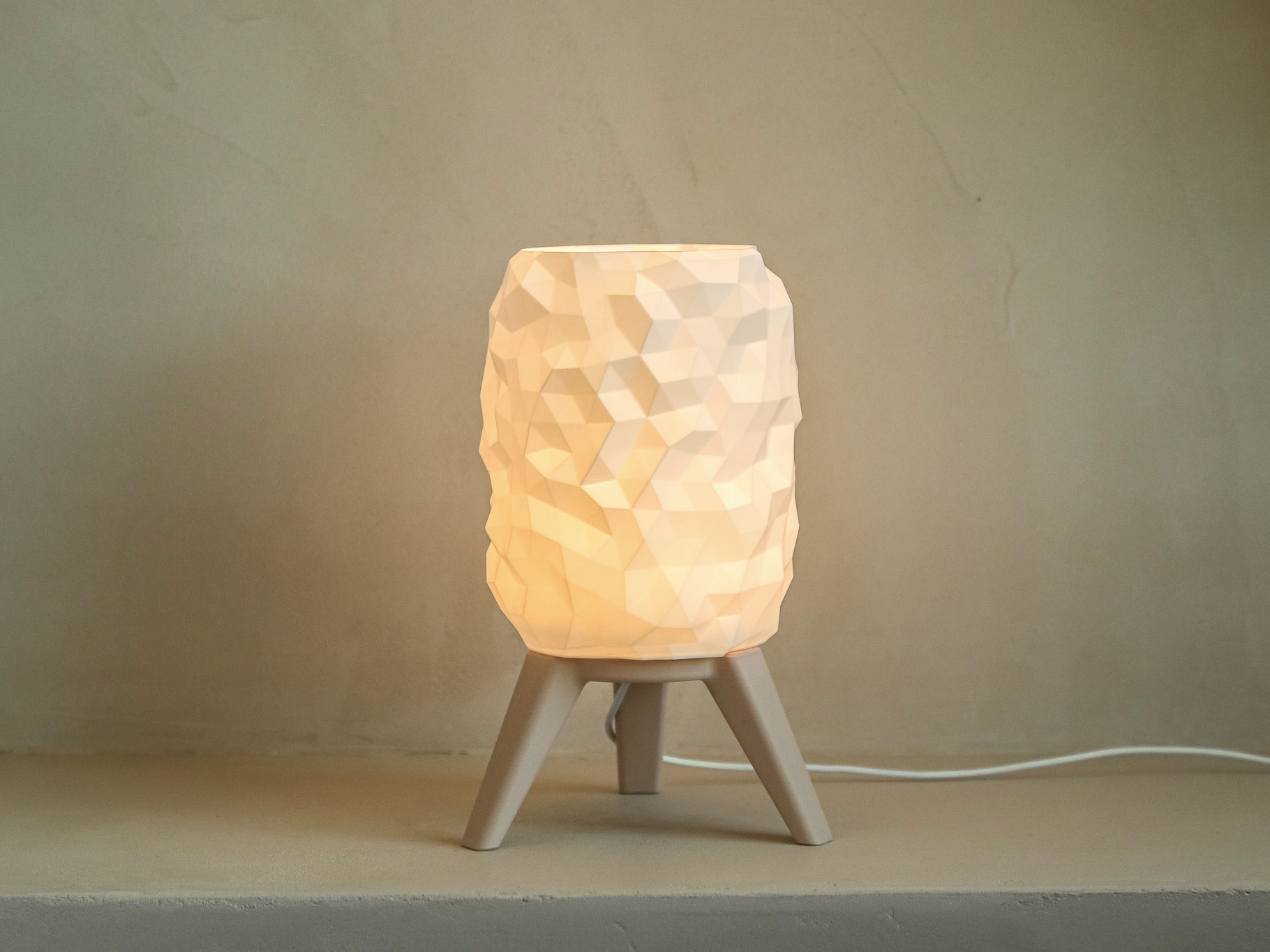 Small lamp with a textured white shade on a beige background
