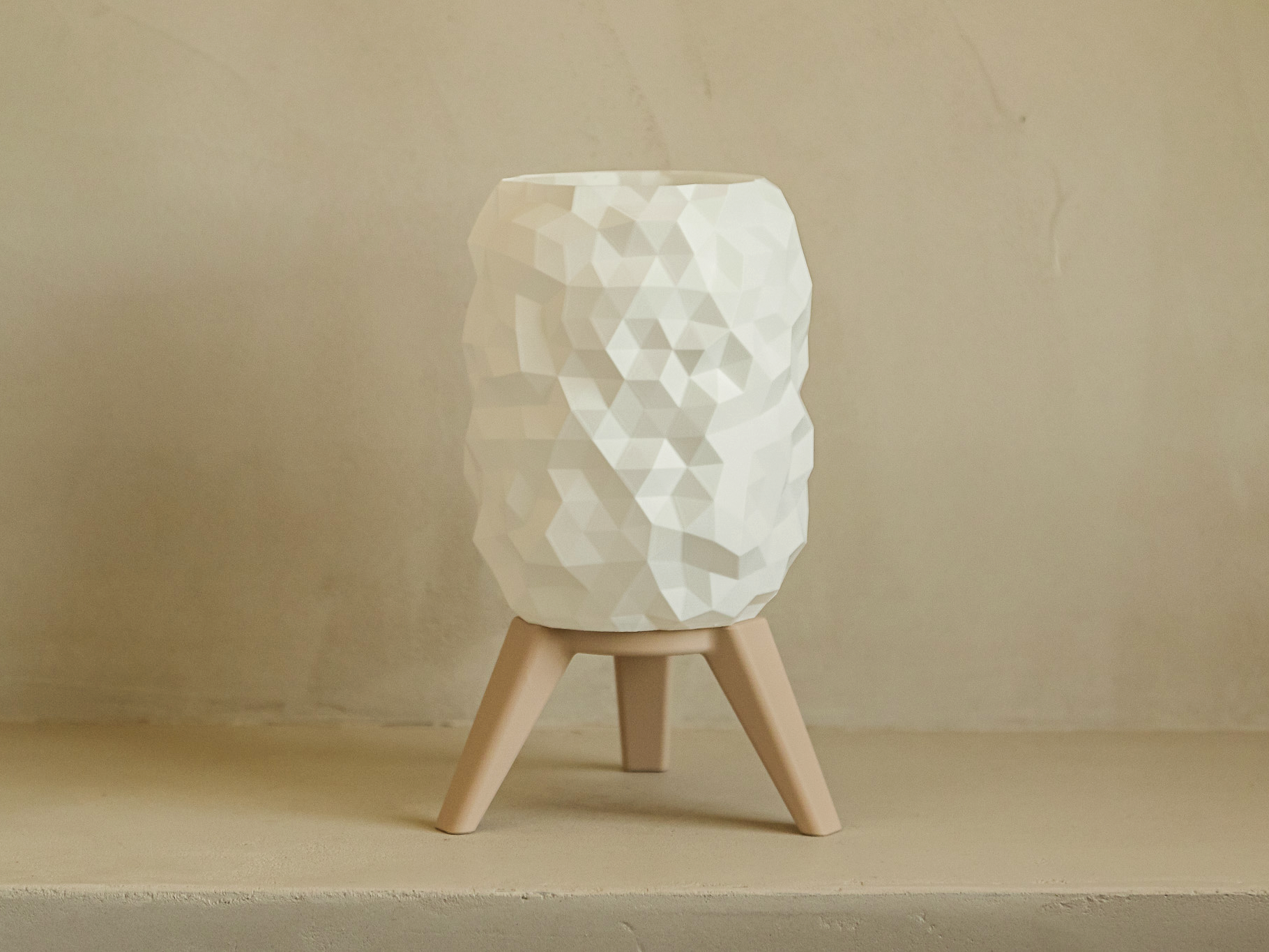 White textured lamp on a wooden base against a beige background