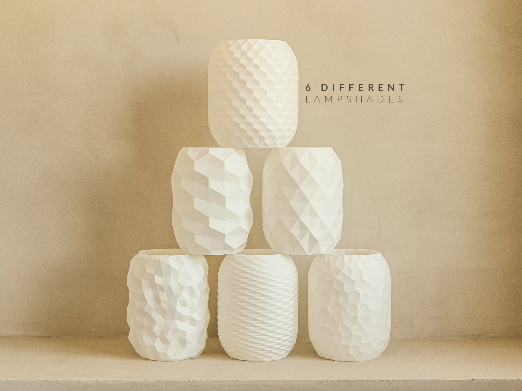 Stack of six different textured lampshades on a beige background